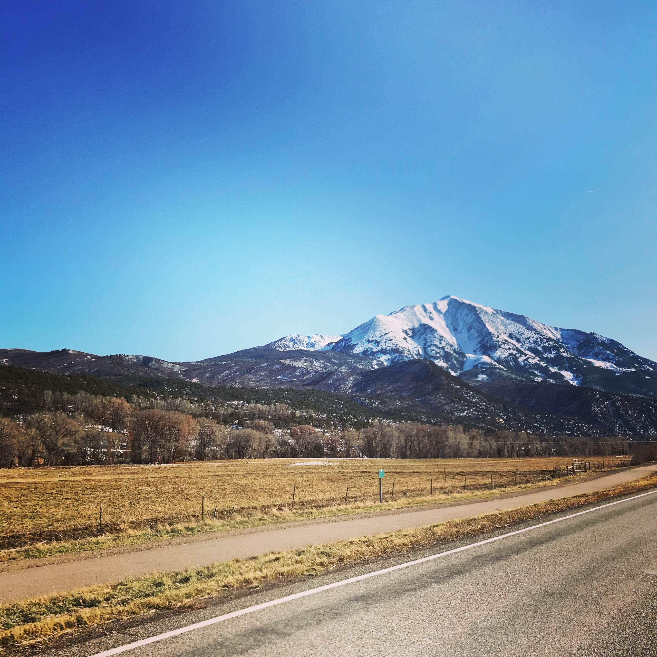 A roadside photo of Mt. Sopris with snow on the peak.